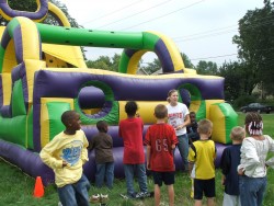 Photo of children playing with inflatable games.
