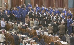 photo of Drake basketball teams getting a standing ovation from representatives in the House Chamber