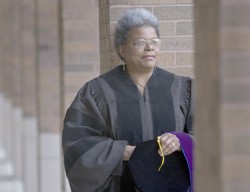 photo of Deb Turner tossing cap in air after graduation