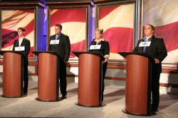 Photo of students standing at podiums in Sheslow Auditorium