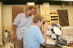 Andrew Johnson and Keith Summerville looking through microscope