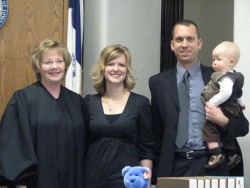 photo of family with judge on Adoption Saturday