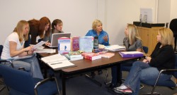 photo of students working with professor Sally Beisser