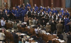 photo of standing ovation for basketball teams in House Chambers