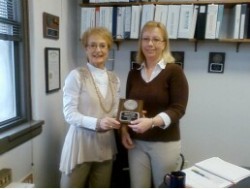 Mary Jo Smith, left, hands the Meritorious Service Award to Kristi Fuller.