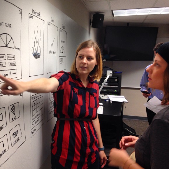 Graphic Design professor Amanda Marrow works with magazine major Raeann Langas about her group's app architecture.