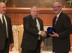 Jim Wallace, BN'77, at right, shakes hands with Stuart A. Klugman, during the Actuarial Science Alumni Evening. Jim Noyce, BN'78, is on the left.