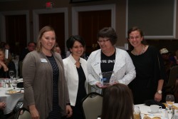 Renee Sedlacek, left, Mandi McReynolds, and Martina Wolf accept the 