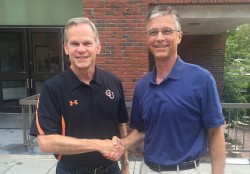 President Marty Martin, right, shakes on the agreement with President J. Bradley Creed.