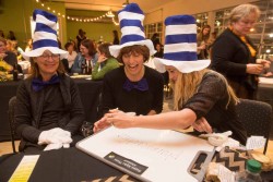 Kathleen Jones, (from left) Masha Quinn and Anne Feldman, all of Des Moines, write the spelling of a word Friday, Nov. 14, 2014, during Drake University’s Adult Literacy Center's First Annual Adult Spelling Bee at the Des Moines Social Club.