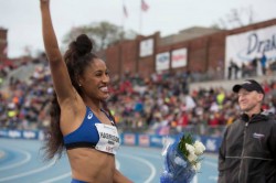 Track star Queen Harrison celebrates a Drake Relays victory.