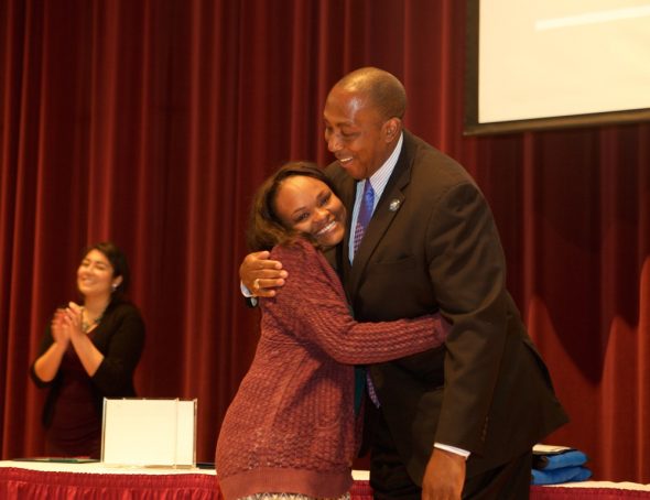 Brytani Cavil, senior marketing major in the College of Business and Public Administration at Drake University, hugs Dean of Students Sentwali Bakari during the Adams Leadership Convocation on Friday, April 22. Cavil, a single mother of two, was named Drake's top senior and will speak at the 140th Undergraduate Commencement Ceremony on May 15.