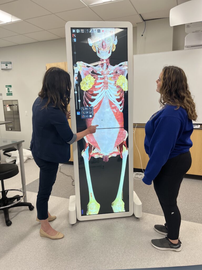 Dr. Alisa Drapeaux shows real human anatomy in 3D form on an Anatomage Table to a student.