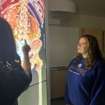 Dr. Alisa Drapeaux shows real human anatomy in 3D form on an Anatomage Table to a student.