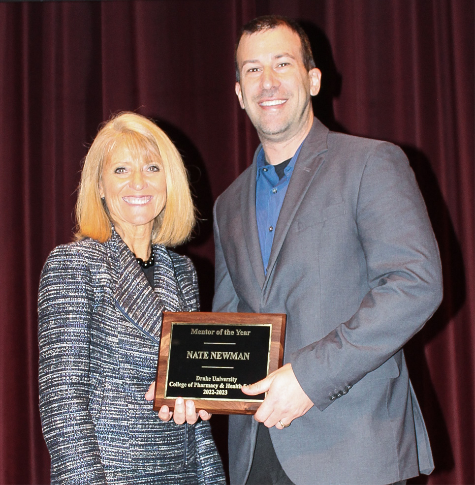 Nate Newman, director of the athletic training program, accepts the Mentor of the Year Award from CPHS dean Renae Chesnut.