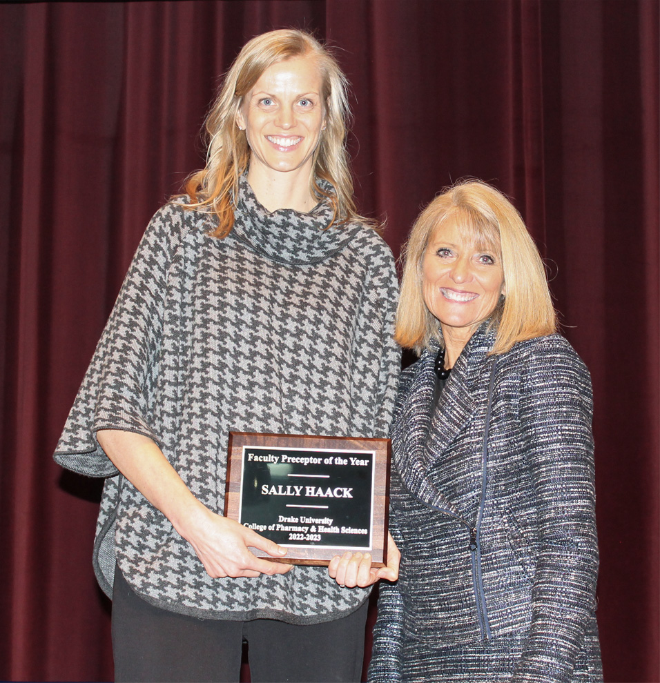Sally Haack, professor of pharmacy practice, accepts the Faculty Preceptor of the Year Award from CPHS dean Renae Chesnut.