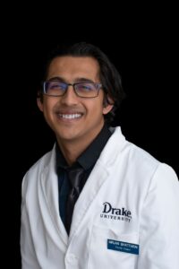 Portrait of rising fourth-year student pharmacist Nirjan Bhattarai in his white coat.