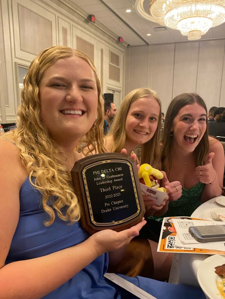 Three Psi Chapter members of Phi Delta Chi pose with the chapter's third place John D. Grabenstein Leadership Award Plaque at the National Grand Council Meeting on Aug. 3-5, 2023 in Houston, Texas