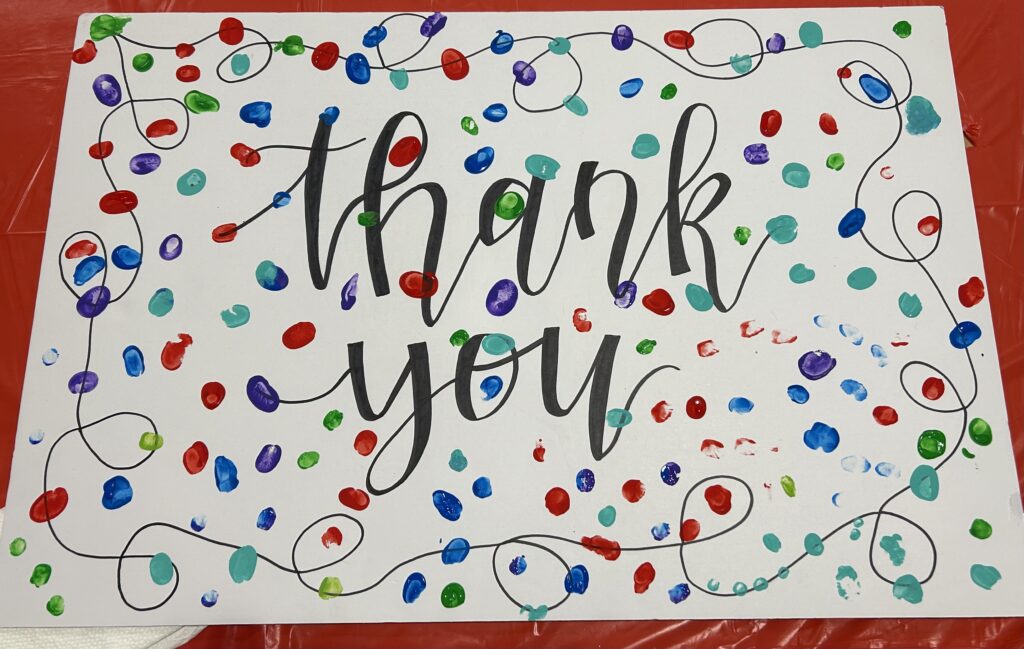 Thank You card decorated with thumbprints of foster children who received gifts from the toy drive