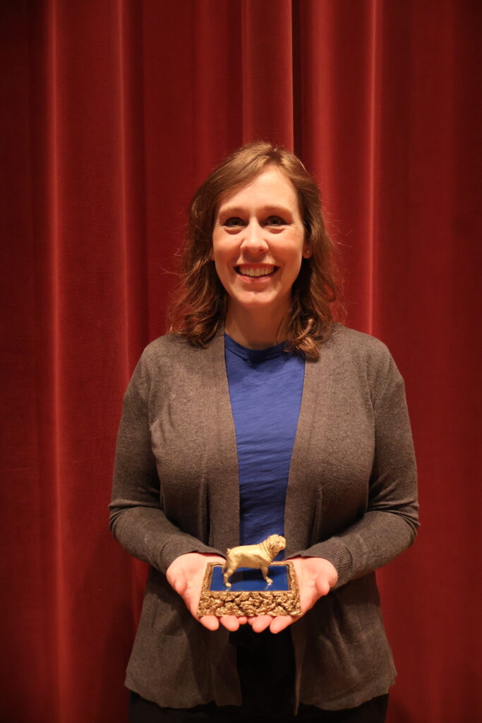 Lynn Kassel holding Morrow award
