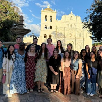 A group of Drake healthcare students pose in front of a monument in Honduras