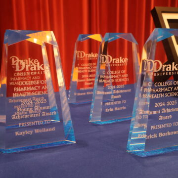 Glass Alumni Achievement award trophies sitting on table