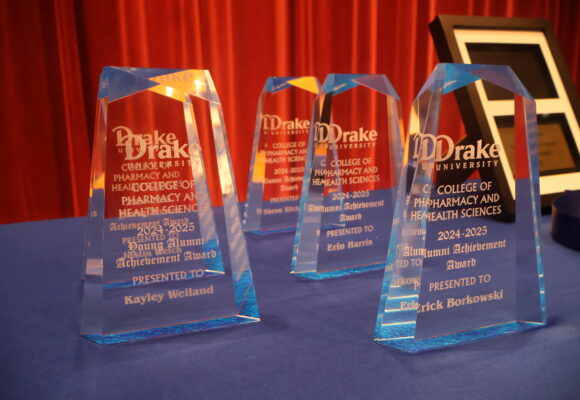 Glass Alumni Achievement award trophies sitting on table