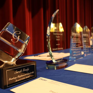 Faculty awards sitting on table on a stage